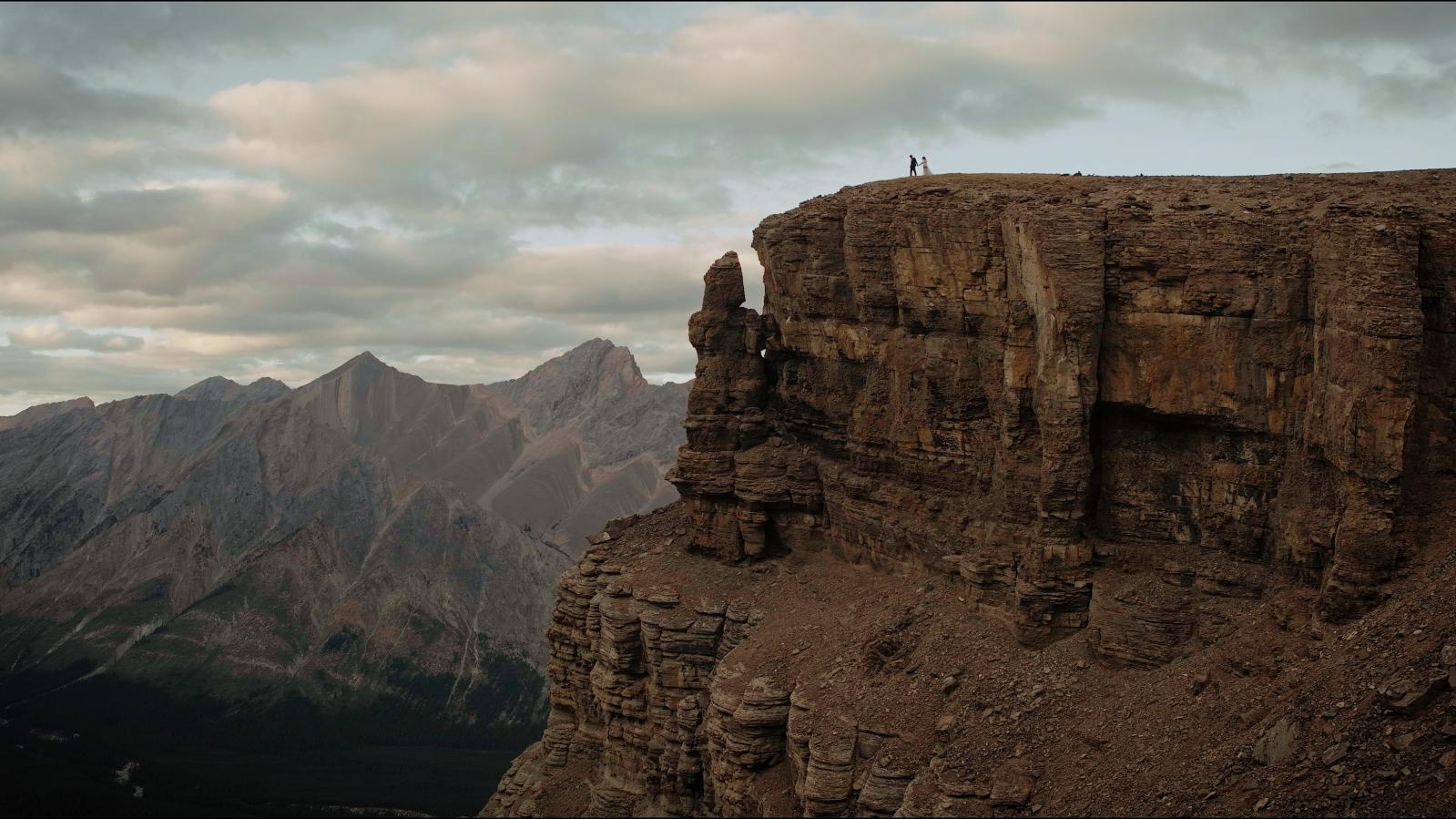 Wedding Photo, couple up on cliff, vista view in background