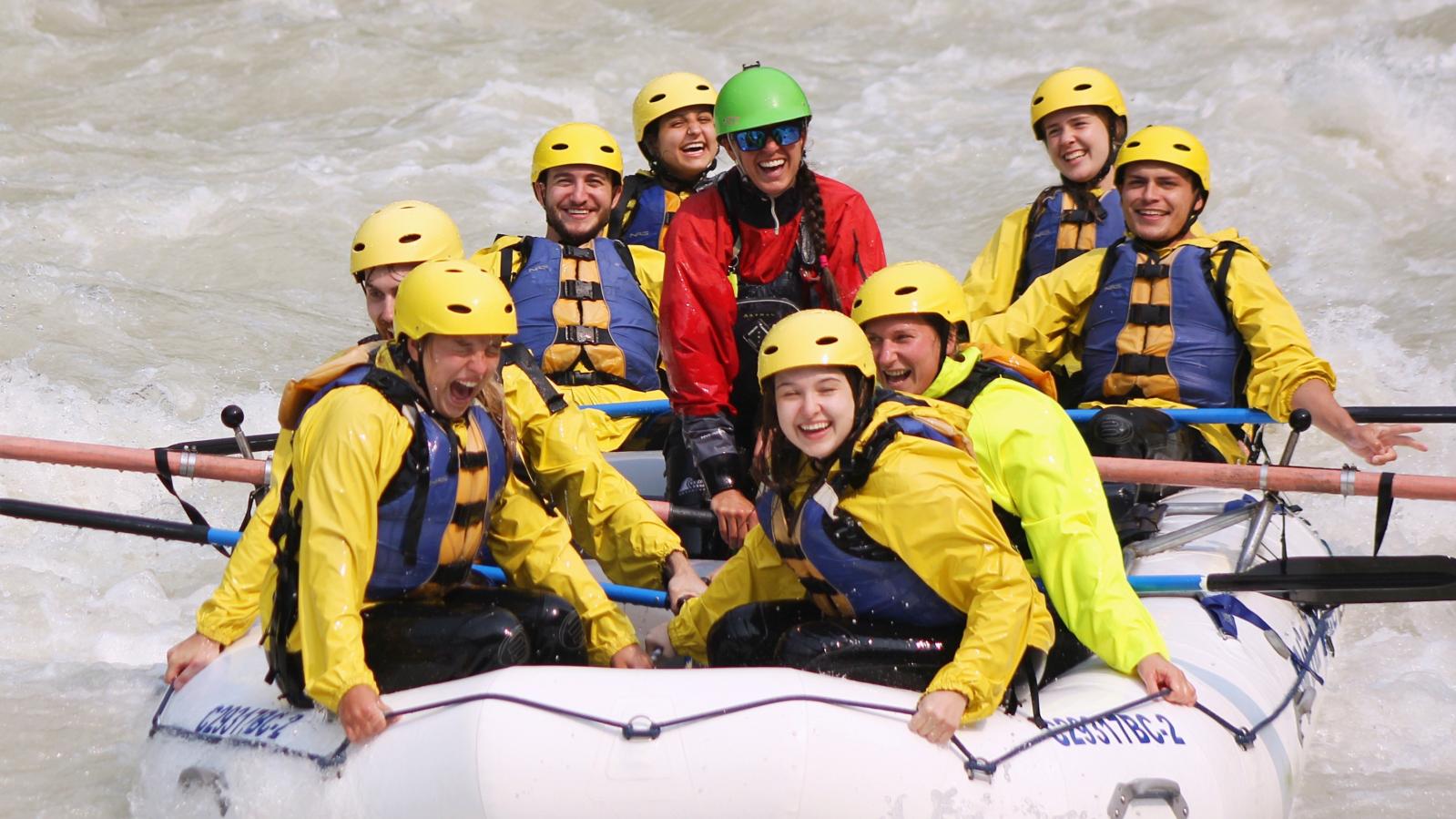 Whitewater rafters in a white raft enjoy the Kicking Horse River whitewater.